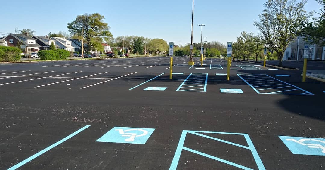 New parking lot layout with accessible parking signage at Aetna